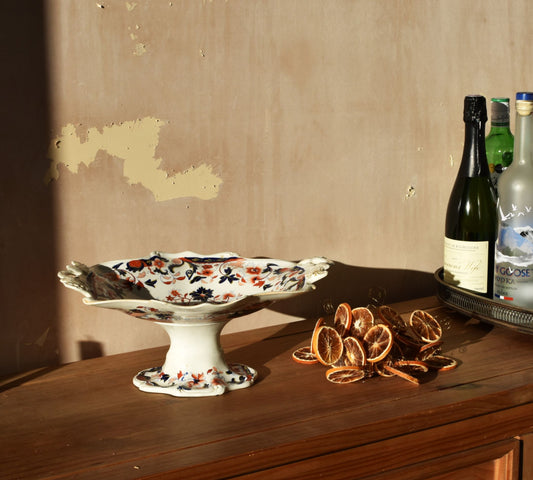 a floral raised dish on a wooden table