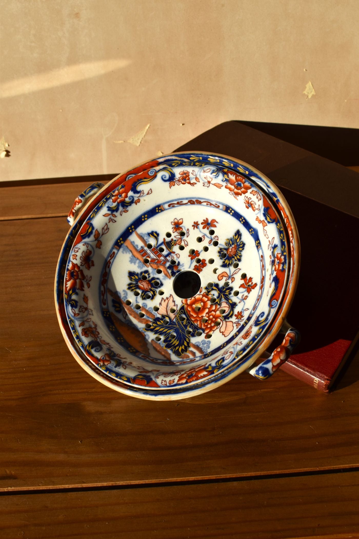 Decorative ceramic plate with floral patterns on a wooden surface