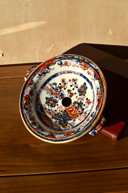 Decorative ceramic plate with floral patterns on a wooden surface