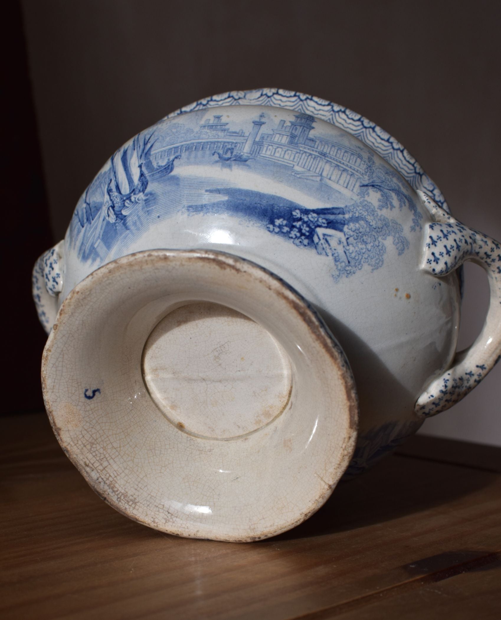 Blue and white ceramic vase with intricate patterns on a wooden surface