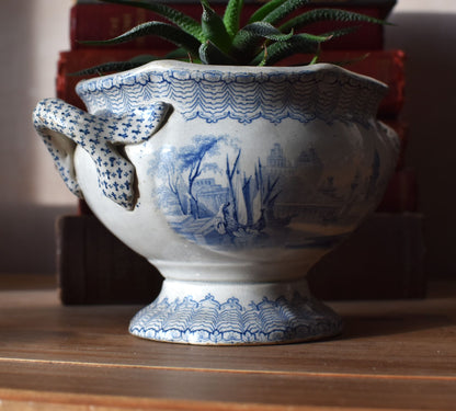Decorative white vase with blue patterns on a wooden surface