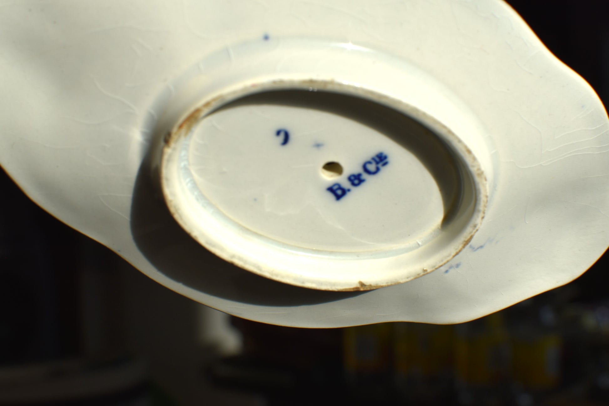 the white bottom of the dish has a maker's mark of B&C LE