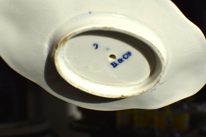 the white bottom of the dish has a maker's mark of B&C LE