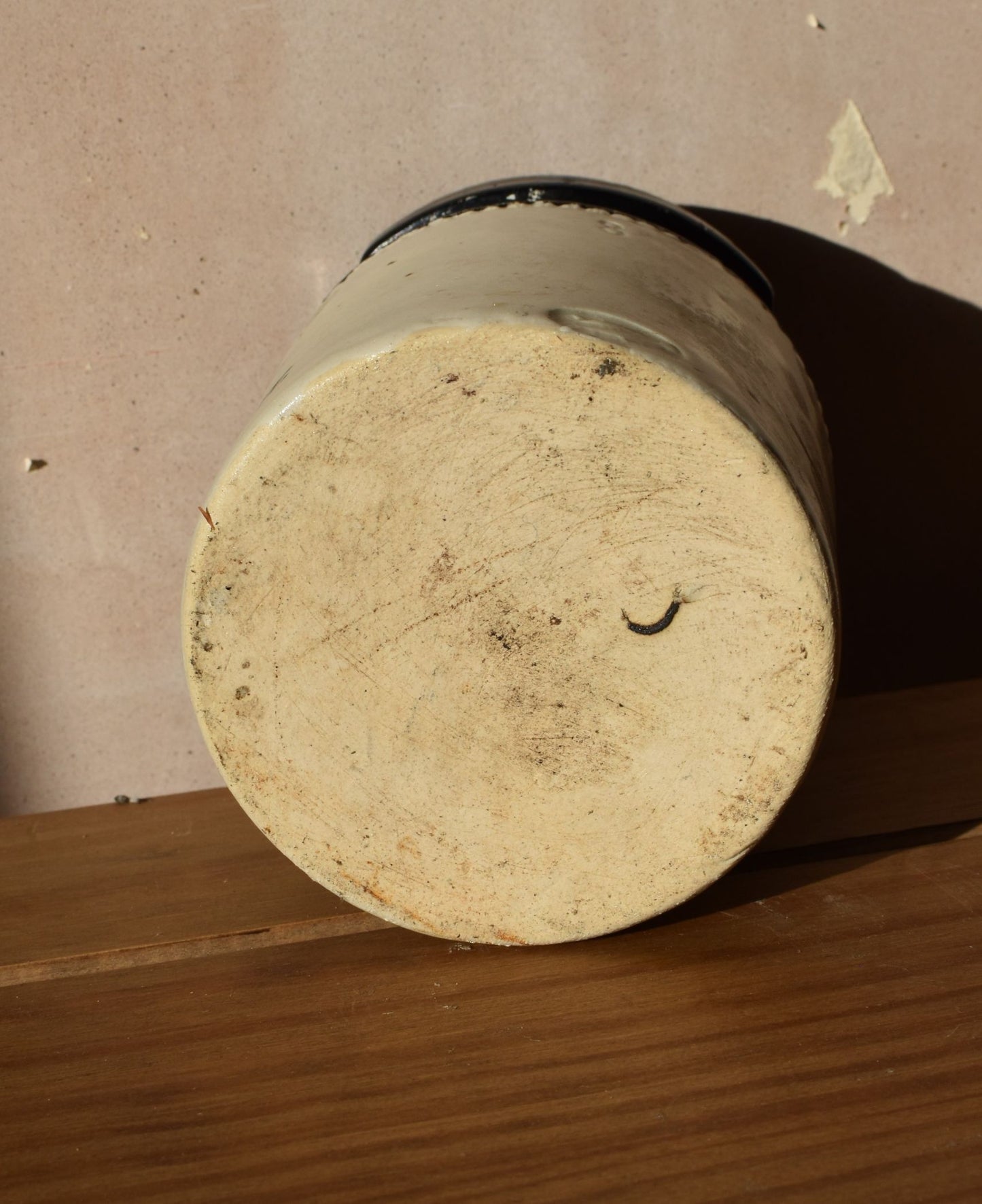 Round concrete block with a textured surface on a wooden surface