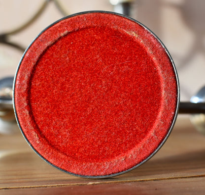 the bottom of the candle holder is made of red felt in a perfect circle