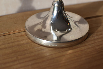 the silver base of the second candlestick