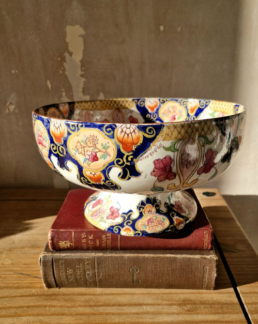 Decorative bowl with floral patterns on a stack of books