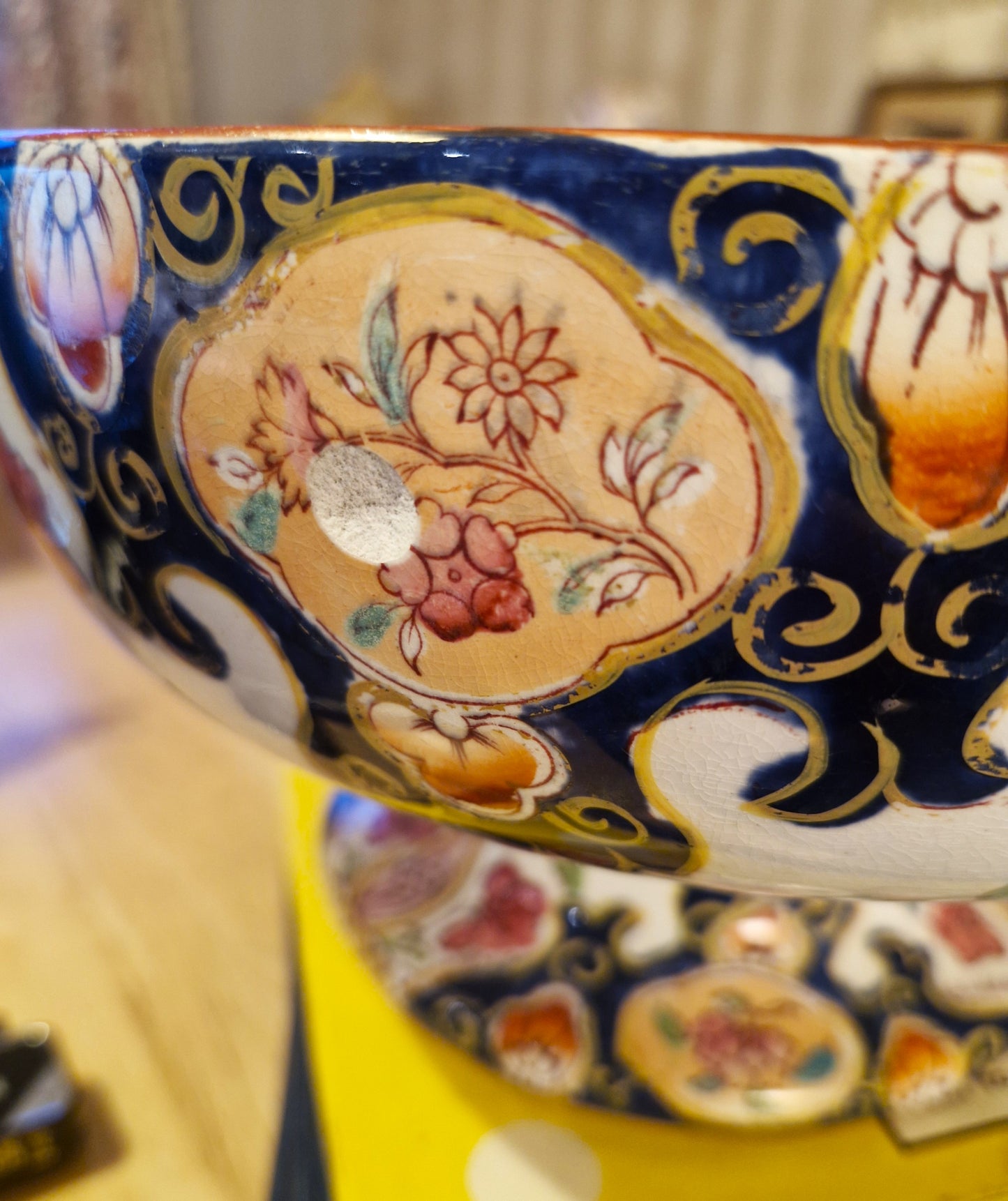 Decorative ceramic bowl with intricate floral patterns on a blue background