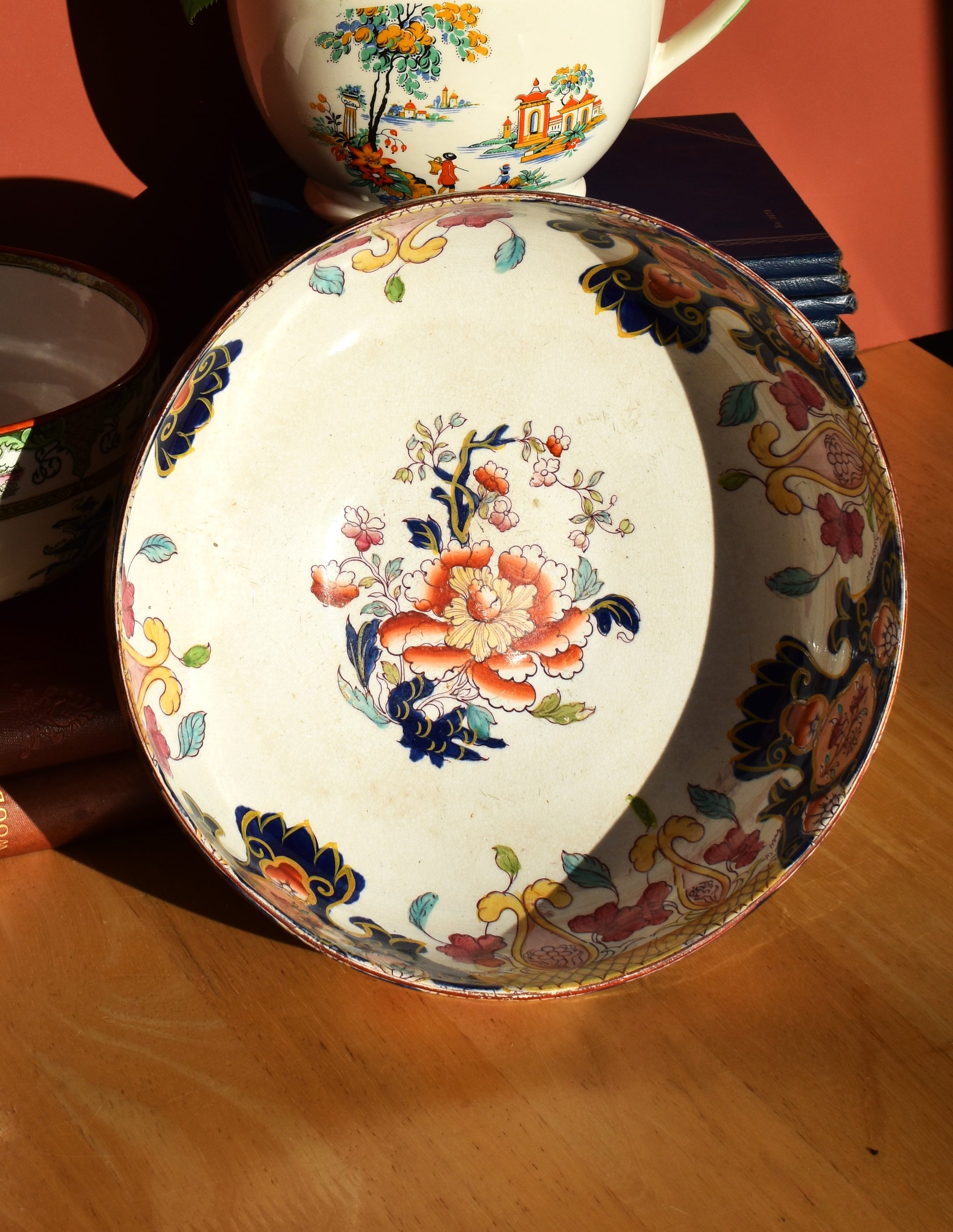 Decorative ceramic plate with floral design on a wooden surface