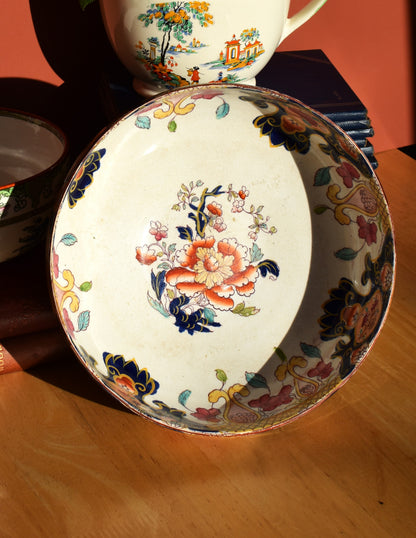 Decorative ceramic plate with floral design on a wooden surface
