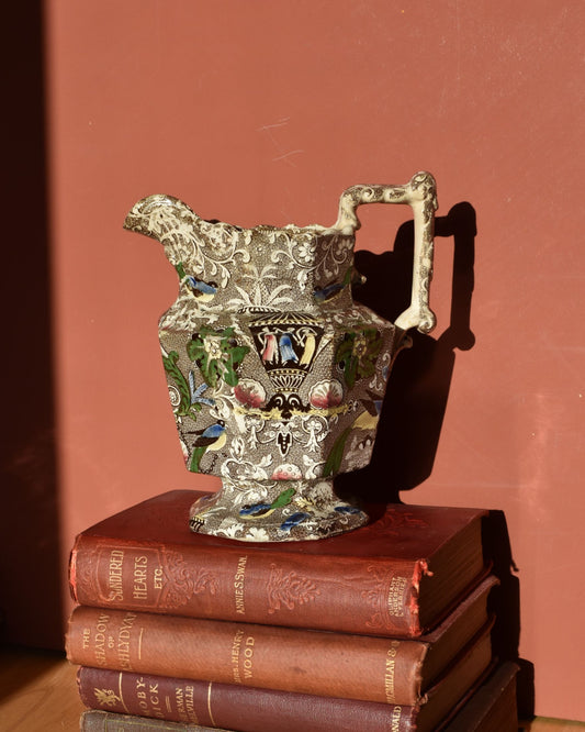 Decorative vase on top of stacked books with a red background