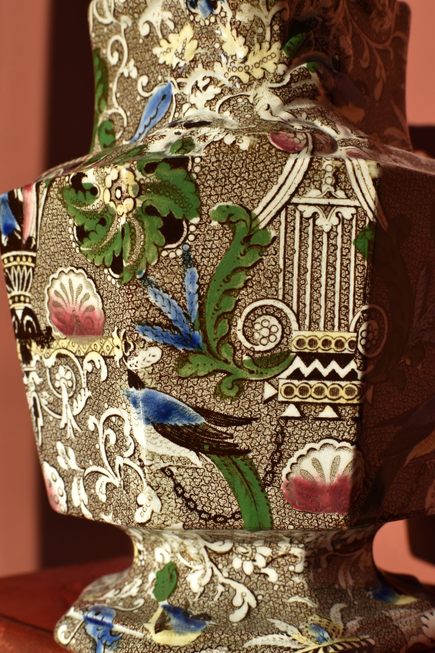 Decorative jug with intricate patterns and colors on a brown background