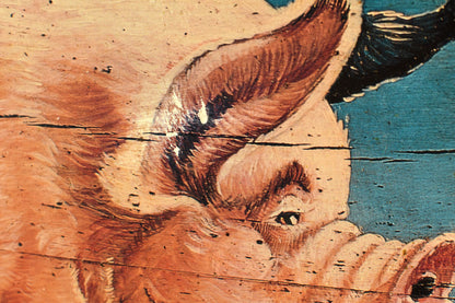 a closeup of the pig's face and ear shows some paint loss