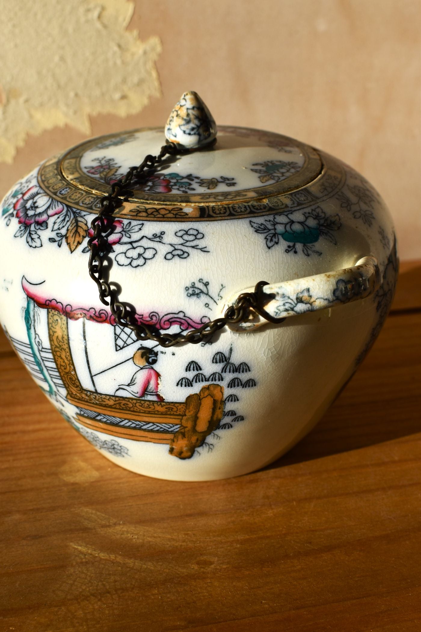 Decorative ceramic jar with lid on a wooden surface