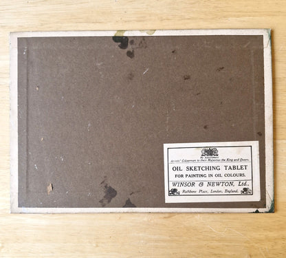 Oil sketching tablet with a label on a wooden surface